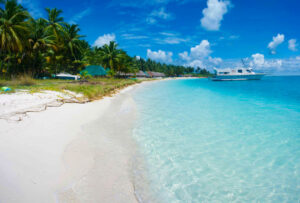 Bangaram's Coconut-fringed Shore, White Sandy Beach, and Sunlit Aqua Waters