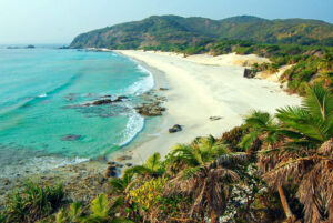 Tranquil shores and lush hills frame the pristine beauty of South Cinque Island Beach in the Andaman and Nicobar Islands