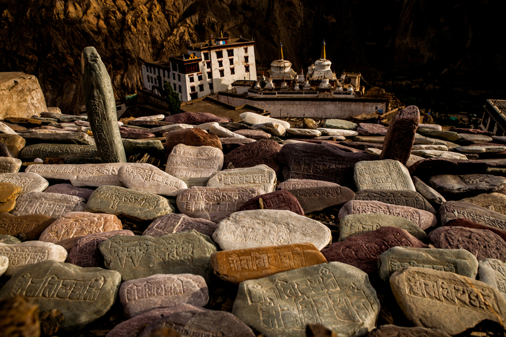 These ancient petroglyphs, found on the path to Meditation Hill in Lamayuru, Ladakh, feature Tibetan script meticulously carved into stones that mirror the vibrant colors of Ladakh's mountains, blending art with the natural landscape.